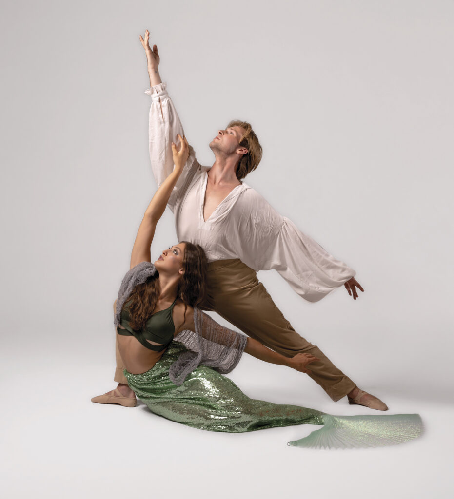 State Street Ballet dancers playing the Prince and the Little Mermaid, expressing love and reaching skyward together in love